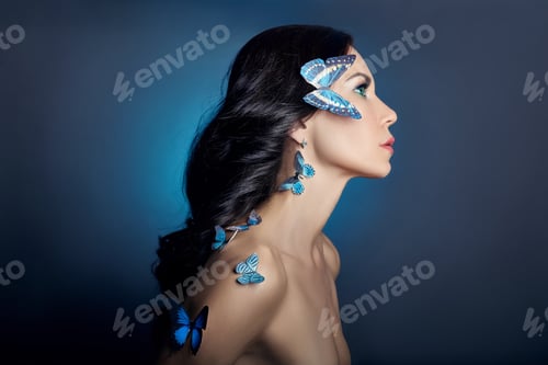 Preview: Beautiful mysterious woman with butterflies blue color on her face, brunette and paper artificial