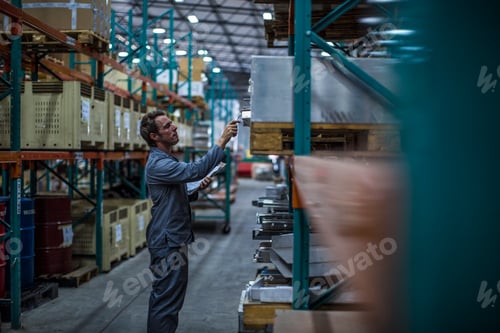 Preview: Worker in factory warehouse taking stock
