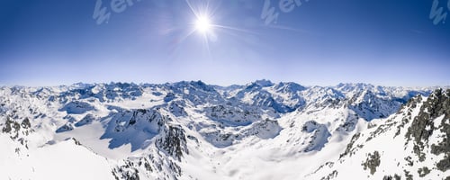 Preview: Beautiful panoramic shot of snow covered mountain ranges under a clear blue sunny sky