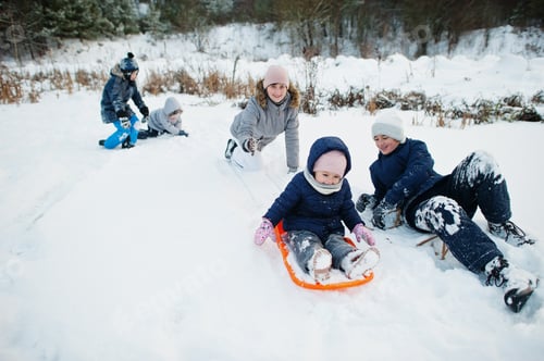 Preview: Mother playing with children in winter nature. Outdoors in snow.