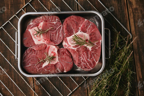 Preview: Top view of raw meat in steel pan ready to cook