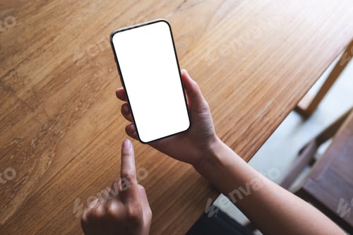 Preview: Top view mockup image of a woman holding mobile phone with blank desktop screen