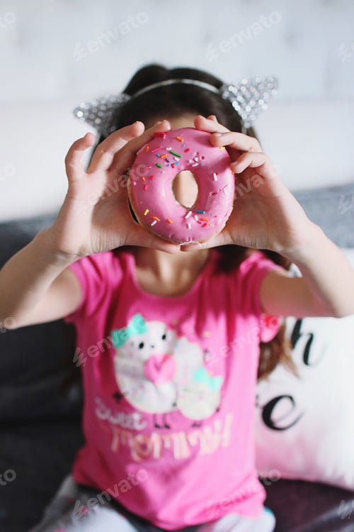 Preview: Child Holds Up Donut To Cover Part Of Face