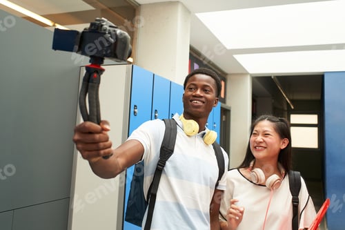Preview: Interracial student couple making a video for social media. Selfie of two young people