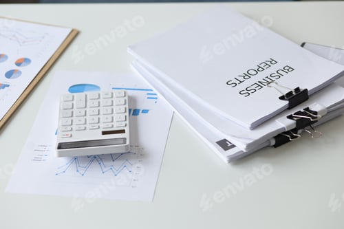 Preview: Close-up of business reports with calculators in the office.