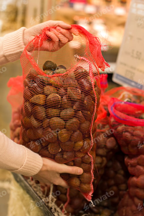Preview: Female Hand Choosing Chestnuts In The Store