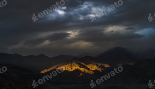 Preview: Beautiful view of a mountain with sun rays and a gloomy sky in the background