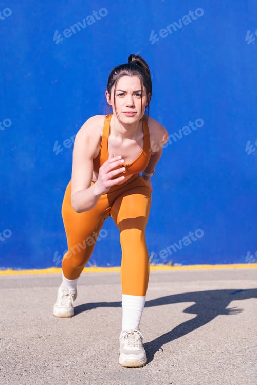 Preview: focused sportswoman in position to start a race