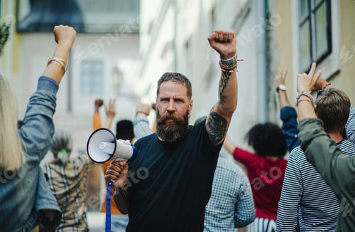 Preview: Portrait of man with megaphone protesting on streets, strike and demonstration concept