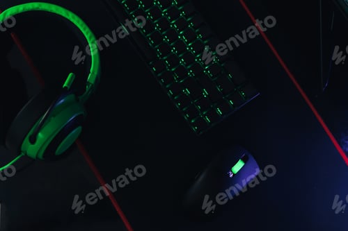 Preview: Gaming accessories with green backlight next to green headphones