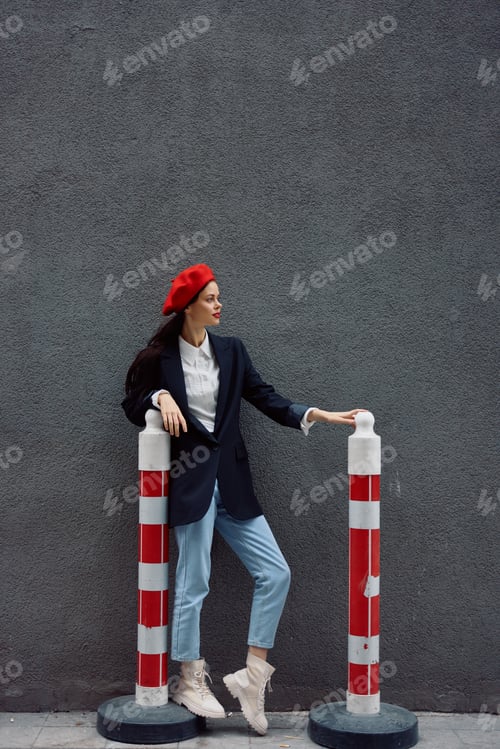 Preview: Fashion woman standing on the street in front of the city and road works tourist in stylish clothes