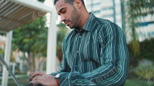 Preview: Close up businessman looking confident using laptop for work on the street