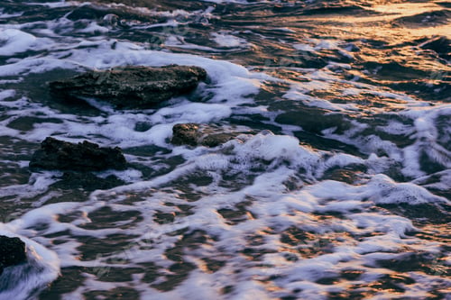 Preview: Blurred abstract background of sea water with waves and foam. Motion blur. Nature.