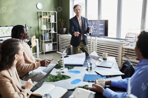 Preview: Businessman giving report for colleagues at presentation