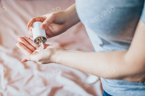 Preview: Woman Pours Pills into Hand at Home