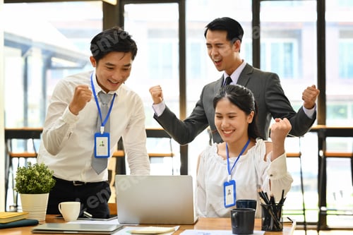 Preview: Happy employees team celebrating at the meeting room.