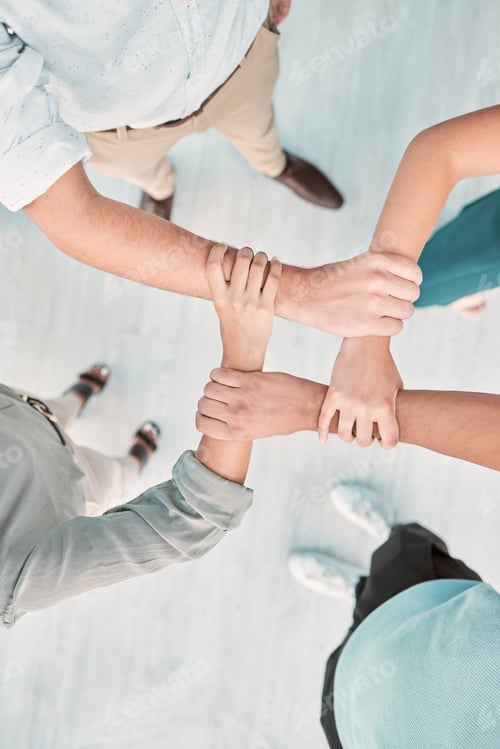 Preview: Hands, collaboration and unity with a business team holding arms in an office together from above.