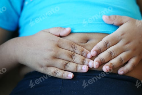 Preview: child suffering stomach pain close up.
