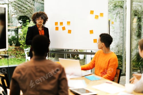 Preview: North African American man giving a presentation to a small group of students