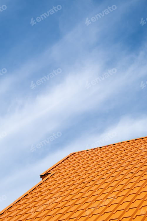Preview: Bright orange roof of metal roofing against blue sky
