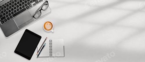 Preview: Top view of the modern workplace desk with laptop, tablet, notebook and a cup of coffee