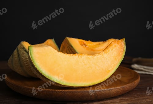 Preview: Tasty fresh cut melon on wooden tray, closeup
