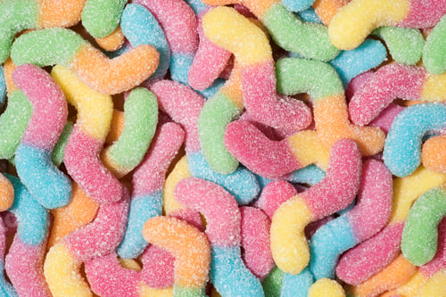 Preview: full frame shot of colorful gummy worms covered with sugar