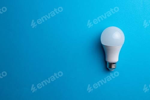 Preview: Light bulb on a blue background with a copyspace