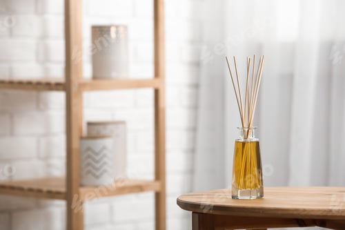 Preview: Reed air freshener on wooden table indoors, space for text
