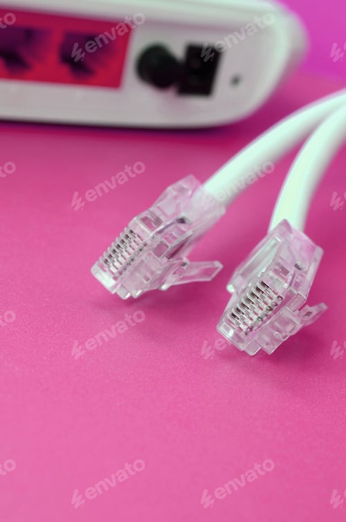 Preview: Internet router and Internet cable plugs lie on a bright pink background