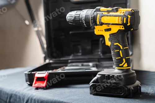 Preview: Black and Yellow Cordless Drill on a Table