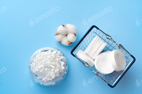 Preview: Set of cotton buds sticks on blue paper