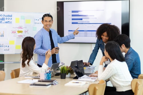 Preview: Professional marketer is making a presentation during a planning business meeting with colleagues.