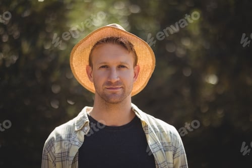 Preview: Handsome young man wearing hat on sunny day at olive farm