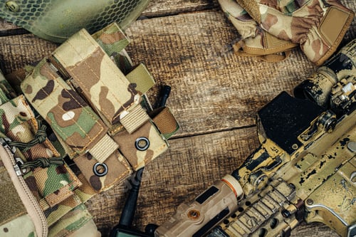Preview: Close up photo of M16 rifle on wooden board