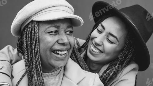 Preview: Happy african girl hugging her mother outdoor - Family and love concept
