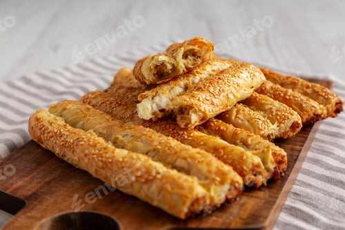 Preview: Homemade Rollini with Chicken on a Wooden Board, side view.