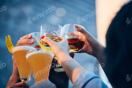 Preview: Closeup shot of many people clinking glasses with alcohol at a toast