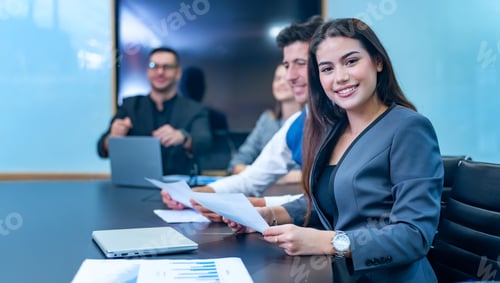 Preview: creative business team at meeting table discussing project with smiling bald man listening to collea