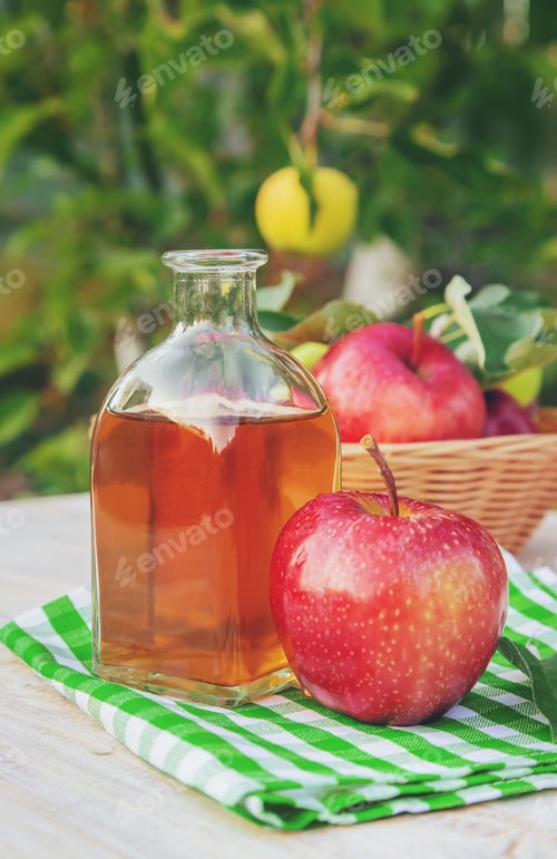 Preview: Apple cider vinegar in a bottle. Selective focus.