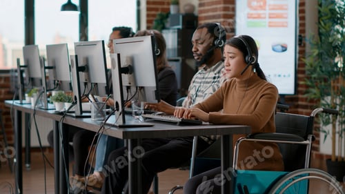 Preview: Asian woman with disability using headset to help clients