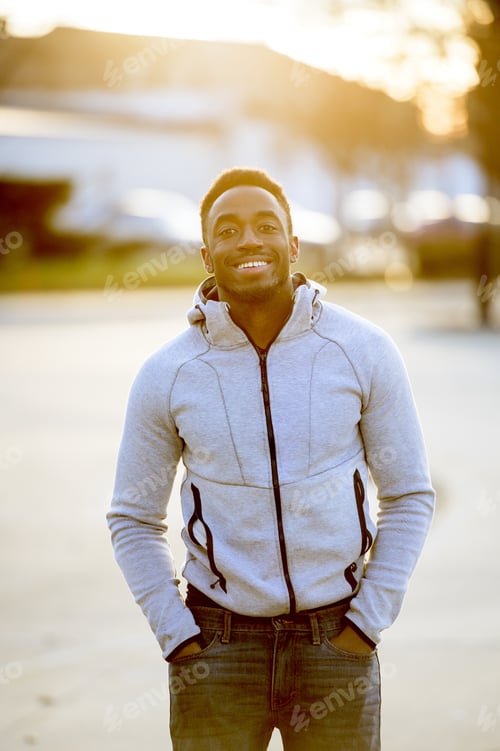 Preview: Vertical shot of an attractive African American male smiling in front of the camera