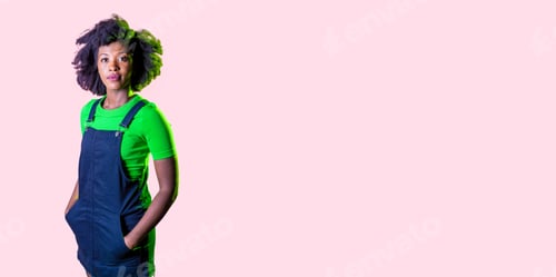 Preview: Young black woman posing isolated staring friendly and relaxed smiling positive