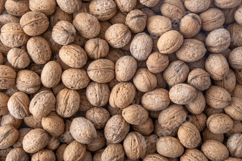 Preview: Walnut in shell. Background view from above. Healthy food top view.