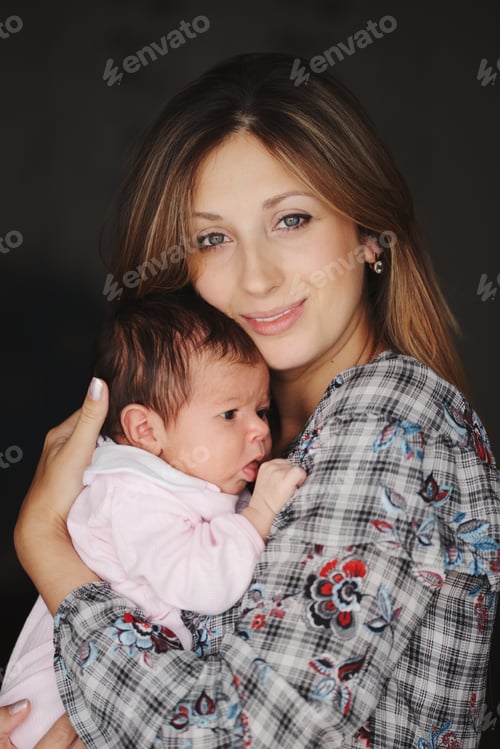 Preview: young mother with cute newborn baby