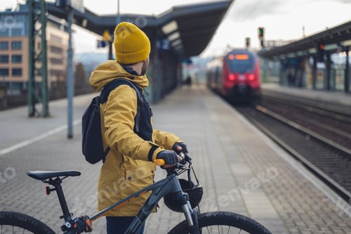 Preview: A man waiting with his bike the train.