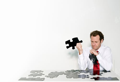 Preview: A business man doing a jigsaw