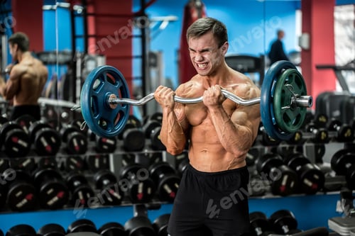 Preview: Very power athletic guy standing workout in the gym.