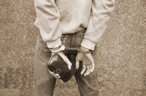 Preview: Arrested drug dealer in police handcuffs with big heroin drug pa