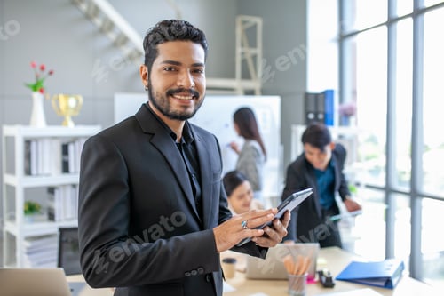 Preview: Portrait of Asian businessman working at the office, businessman using touchpad with smile at office